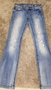Distressed buckle jeans